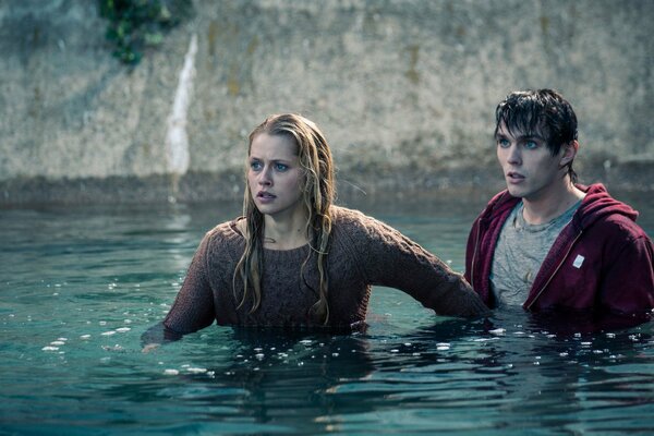 A shot from the film the warmth of our bodies, where Nicholas Hoult and Teresa Palmer are standing chest-deep in water