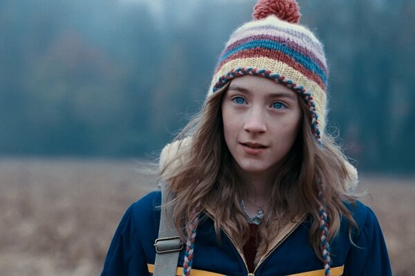 A girl in a field with blue eyes