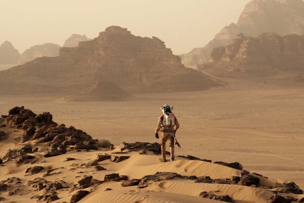 Astronaut in a spacesuit explores the landscapes of Mars