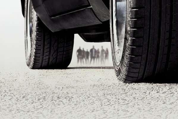 Black and white image of car wheels