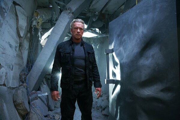 An actor from the Terminator standing in a destroyed building