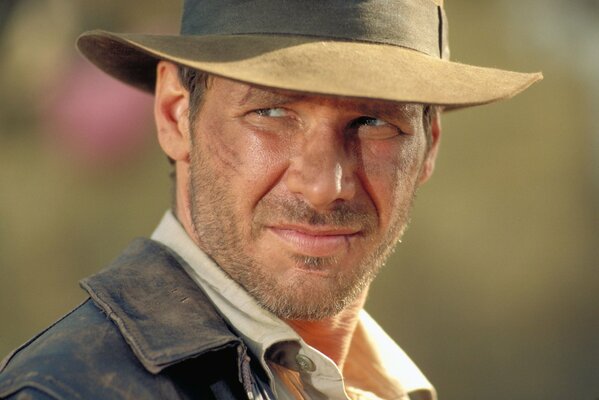 Harrison Ford in a hat , with a light stubble