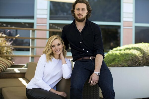 A man and a woman sitting on a sofa