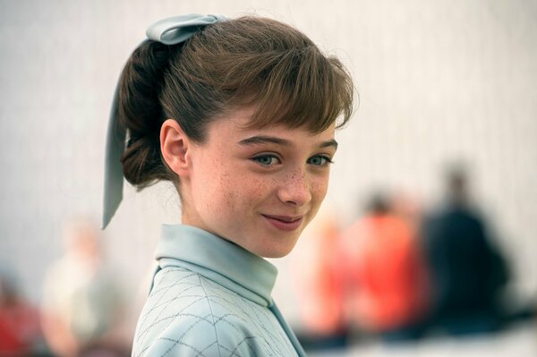 Smiling girl with freckles and a bow