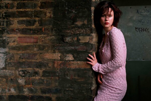 Pensive girl in a pink dress