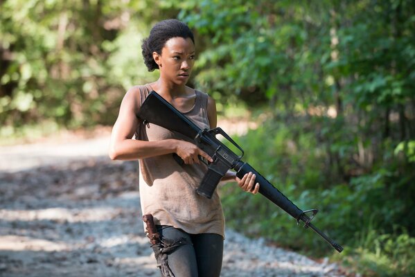 Cute black woman with a gun in her hands