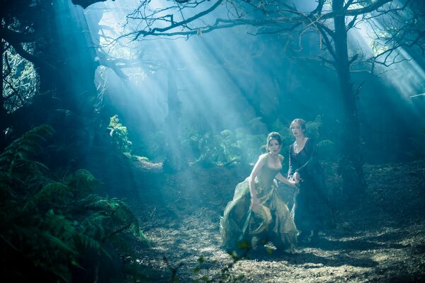 Girls in the forest, the light shines through the trees