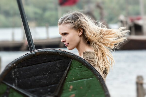 A girl standing with a green shield