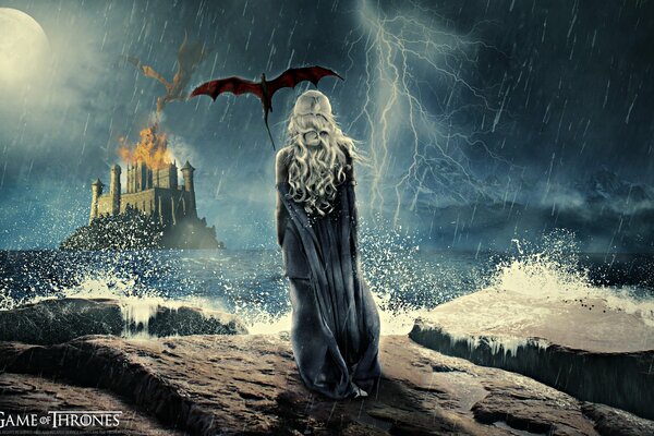 La madre dei draghi si trova su una roccia nel poro e guarda il castello in fiamme