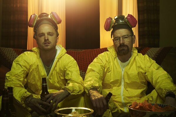 Two men in yellow clothes with bottles in their hands