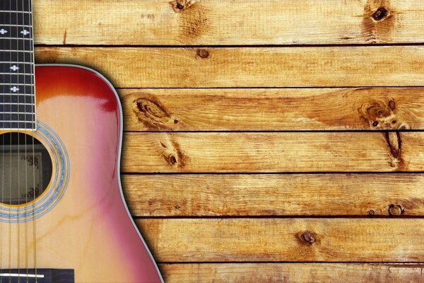 Гитара на фоне деревянных досок