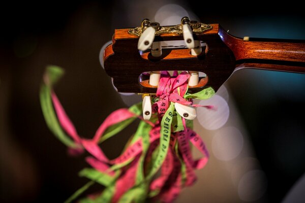 Multicolored ribbons tied to the guitar