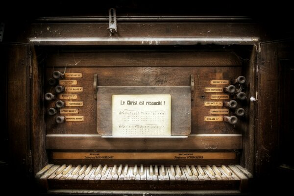 An old organ with notes on a music stand