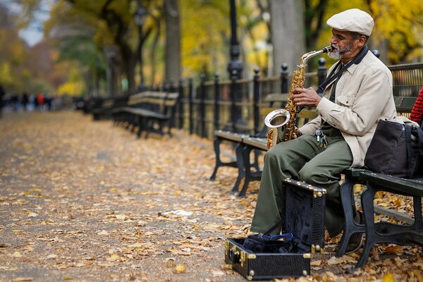 A musician playing the saxophone on the street