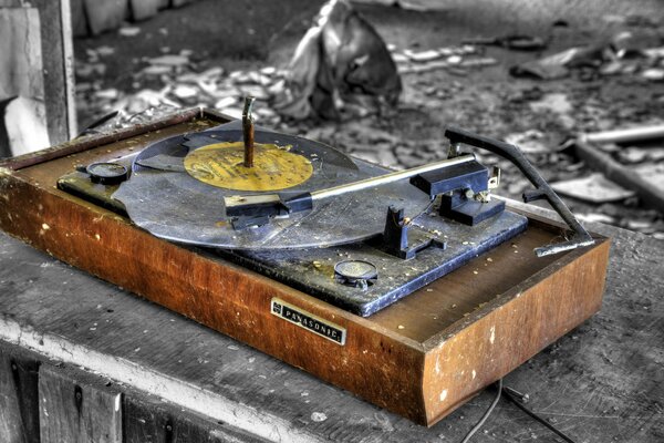 A broken record player in an abandoned room