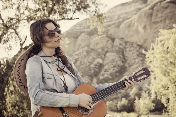 Thoughtful girl playing guitar