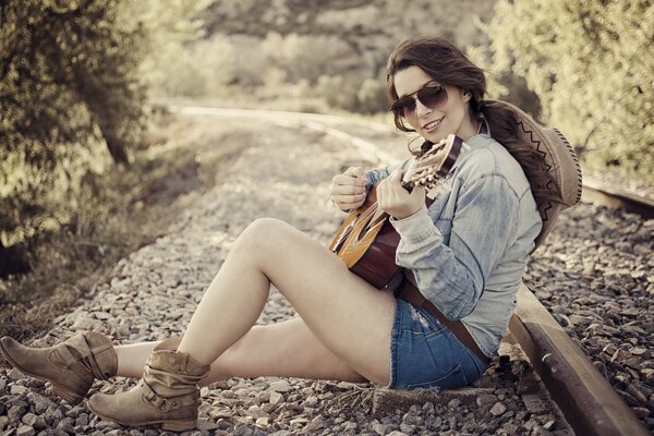 A girl with a guitar. Music in the heart