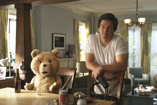 Ted the bear from the movie The Third Extra is sitting drinking beer