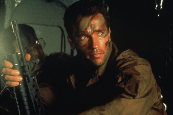 Arnold Schwarzenegger with a machine gun from the movie Predator .