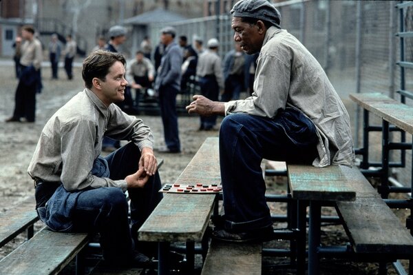 A conversation between two men in prison uniforms