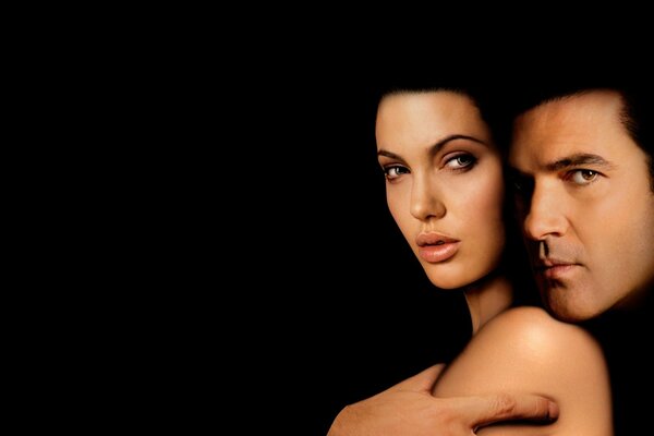Angelina Jolie and Antonio Banderas on a black background