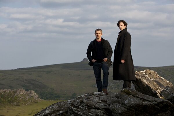 Two in black against a beautiful landscape