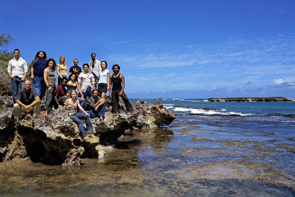 Family on a rocky ledge by the sea