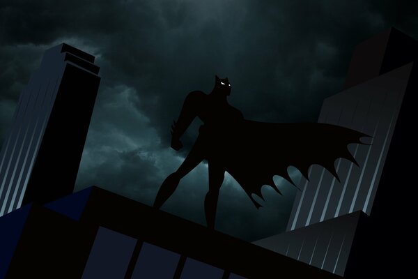 Batman in un mantello in evoluzione sul tetto di notte