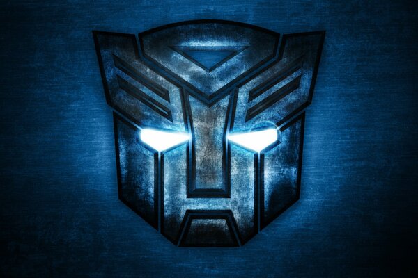 Logo in the shape of an Autobot transformer mask on a blue background