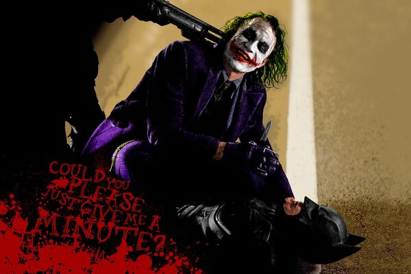 La lutte du joker avec Batman sous la menace d un pistolet