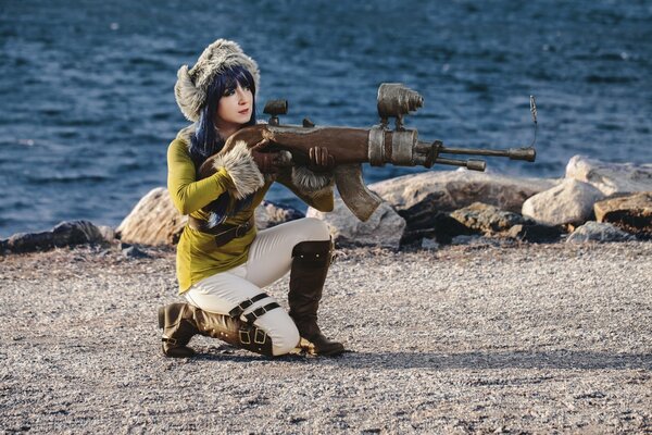 The girl took up a position for firing weapons on the seashore