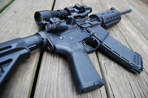 AR-15 assault rifle in black on a tree background