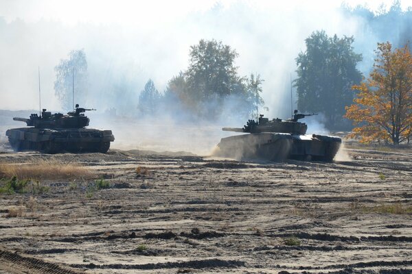 Autumn battle of tanks on the sand