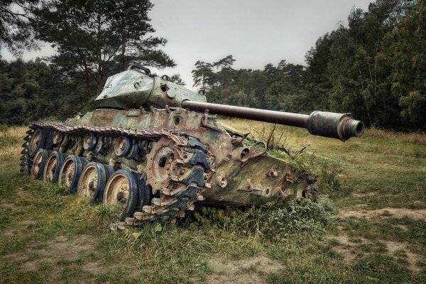 The tank tilted in a field on the grass in cloudy weather