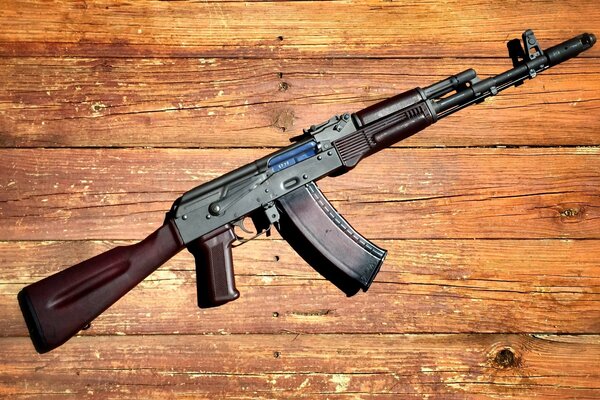 Kalashnikov assault rifle on a wooden background