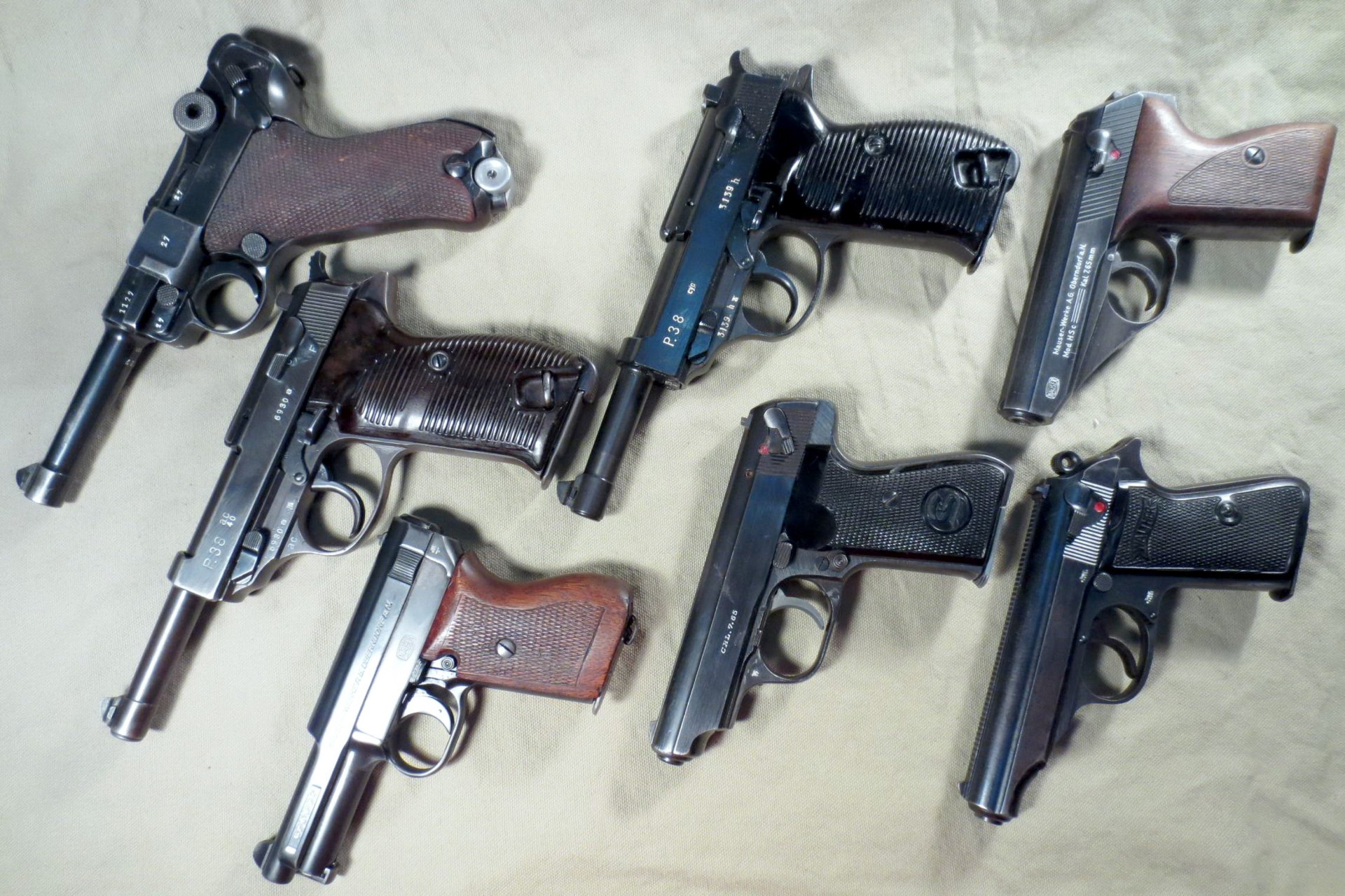 even pistols german self-loading barrels calibers 9 mm and 7.65 mm mauser walter luger parabellum interesting samples super rare weapons active short barrels german metal wood plastic tarpaulin material shadow light background small decent