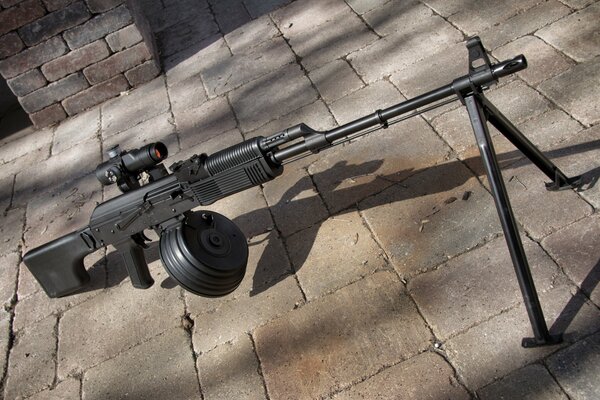 There is a Kalashnikov light machine gun on the road