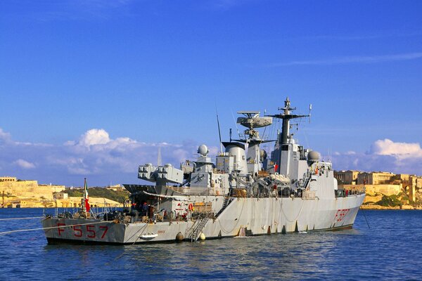 An old warship at the pier. Ship Destroyer on the water