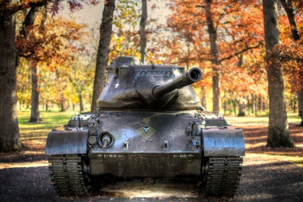 Tank on the background of the autumn forest