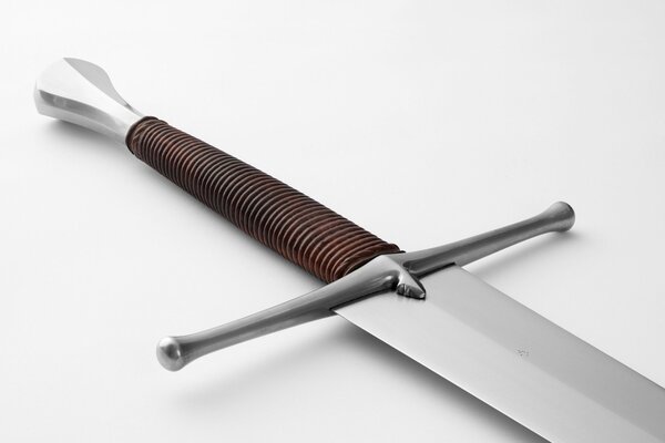 The steel knife lies on a white surface