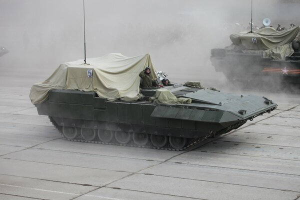 A riding tank under a veil with a soldier