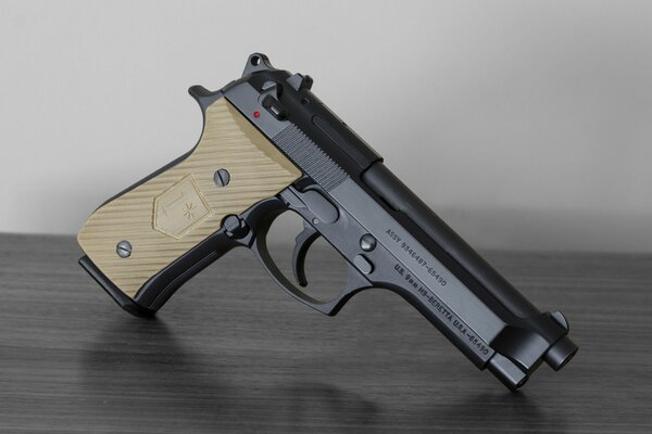 A new pistol with a beige handle