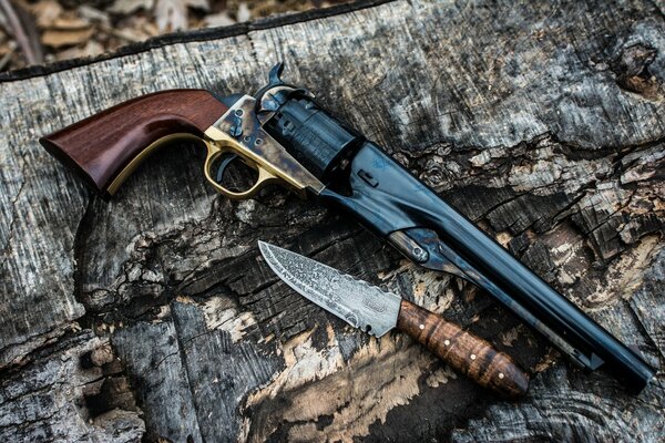 Cold and firearms with wooden handles cartridges in camouflaged