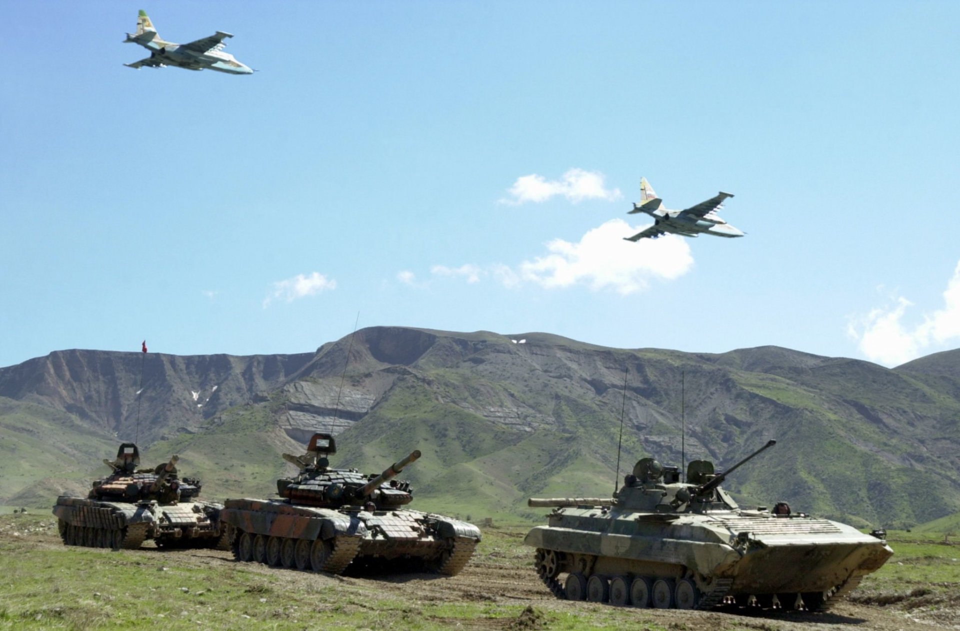 the army russia tank t-80 bmp attack and dry su-25 rook mountain summer sky