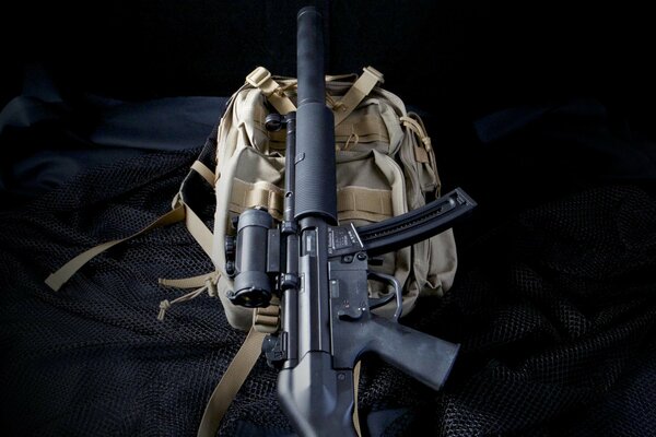 Mp5sd and backpack. Dark background