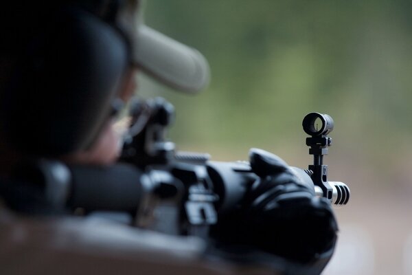 A man takes aim with a sniper rifle