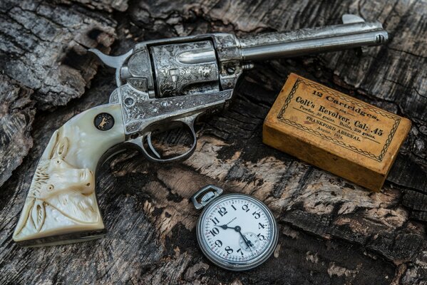 A beautiful composition of revolver, cartridges and watches