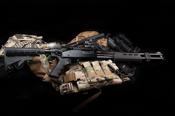 Machine gun and military equipment on a black background