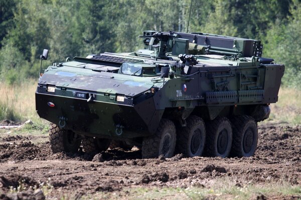 A combat vehicle is driving across the field