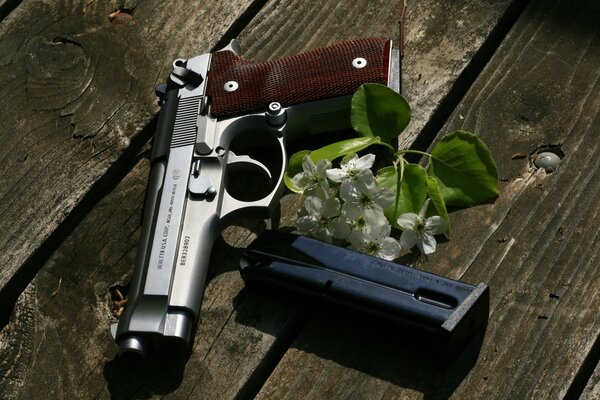 A white flower next to the gun